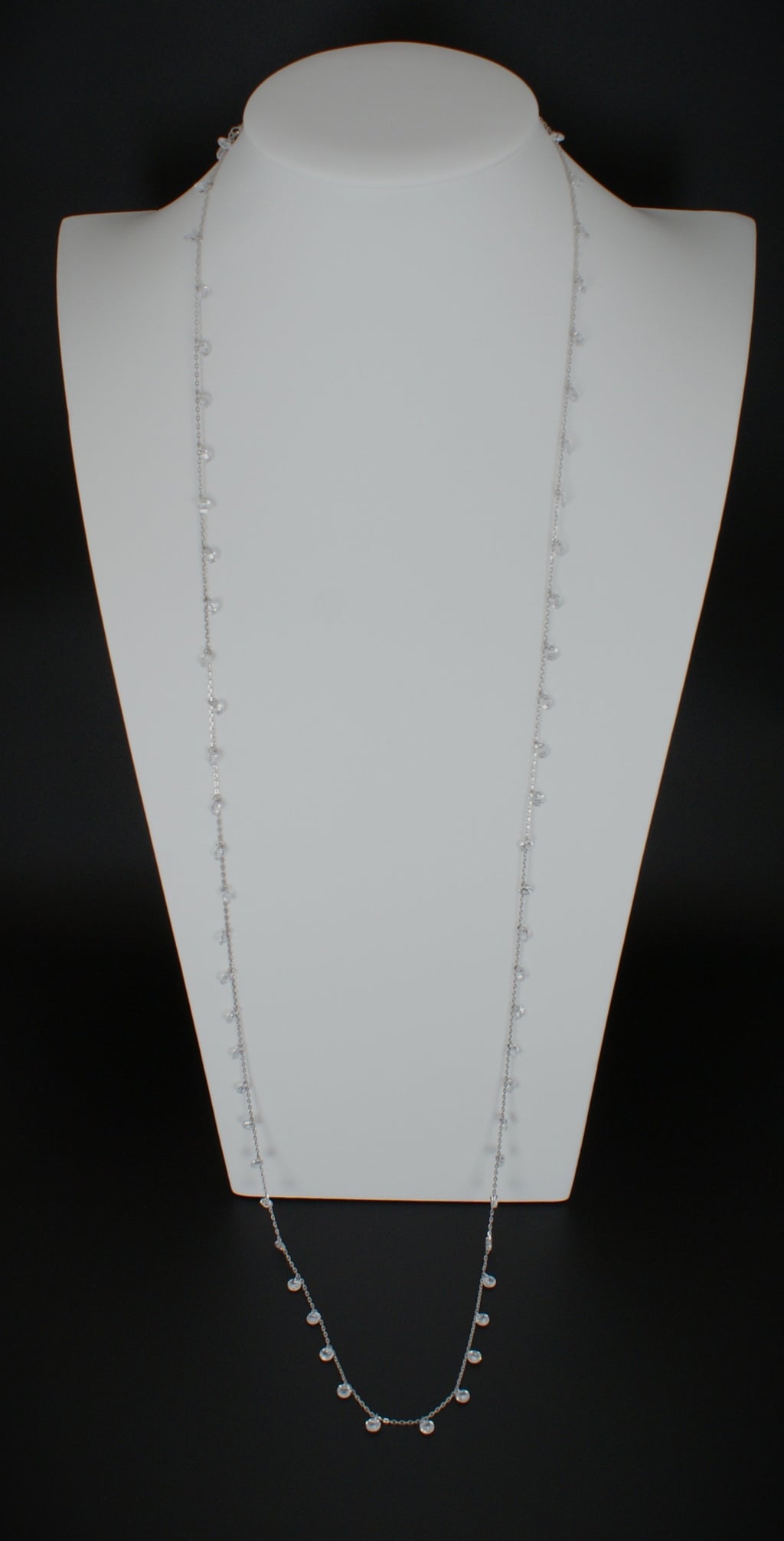 36 inch sterling silver diamond necklace with delicate bezel-set diamonds displayed on white jewelry bust
