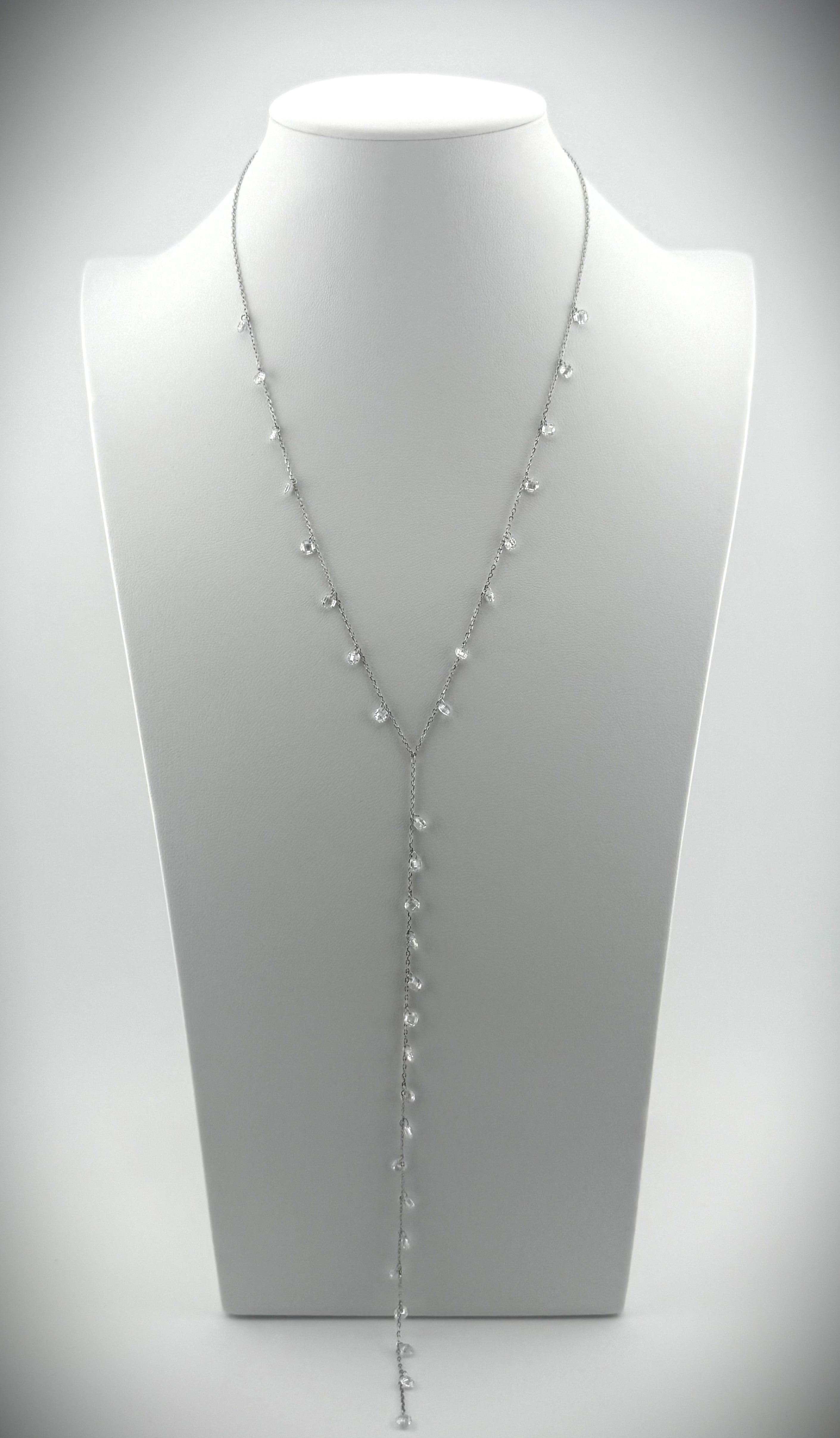 Elegant silver Y-necklace featuring cascading diamond details, styled on a minimalist white bust.
