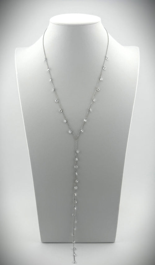 Elegant silver Y-necklace featuring cascading diamond details, styled on a minimalist white bust.