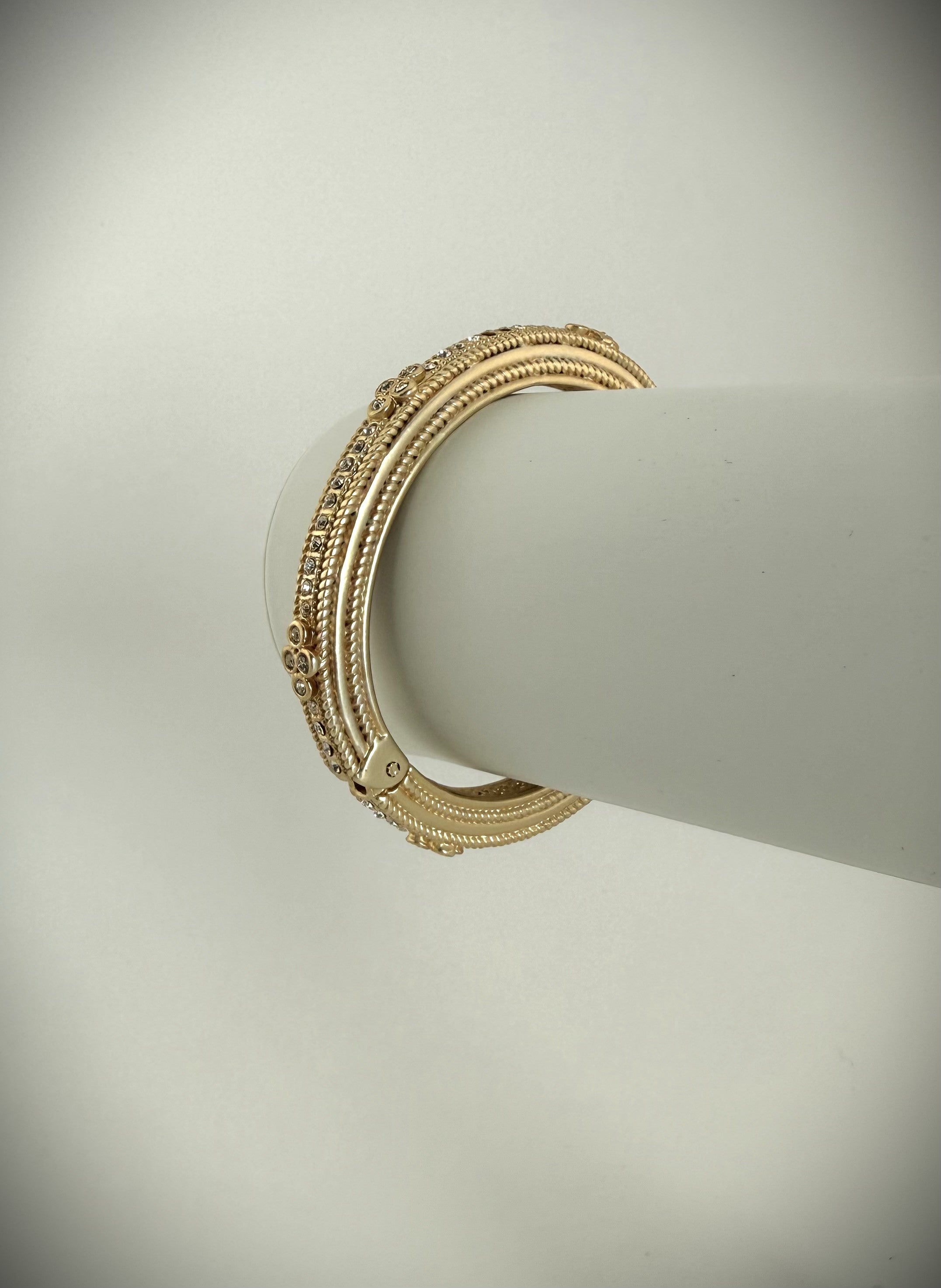 Gold and diamond stackable bracelet on display.