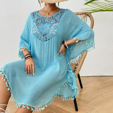 Sheer blue crochet beach cover-up featuring tassel trim and relaxed fit