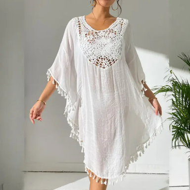 White crochet swim cover-up dress with tassel hem worn over bikini