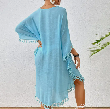 Back view Blue tassel-trim crochet cover-up styled for beach and resort wear