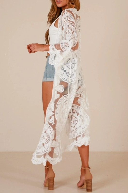Side view of white crochet lace kimono with scalloped hem and flowing silhouette