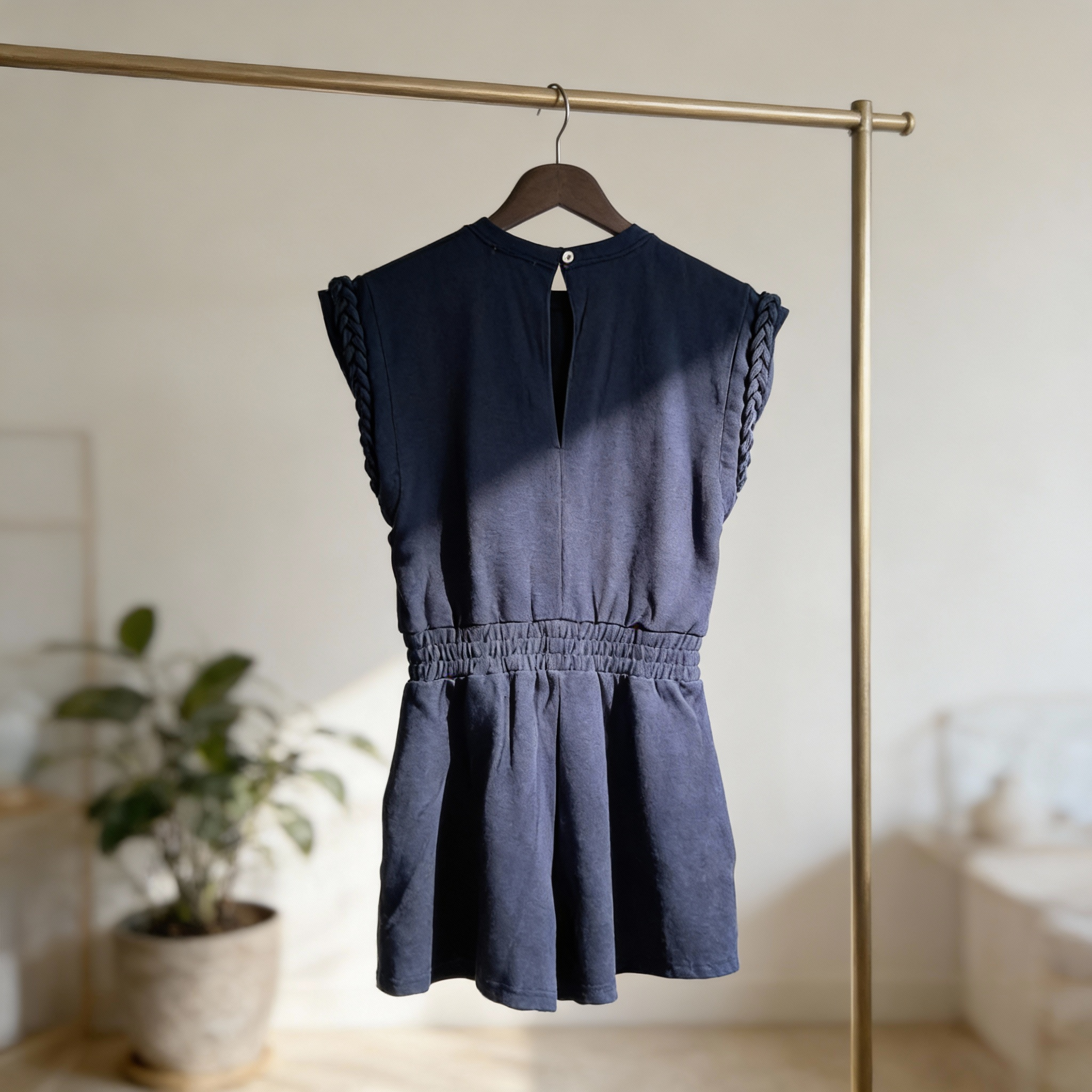 Back view of drop shoulder braided detail knit romper with elastic waist