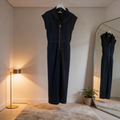 Women’s navy blue drop-shoulder half-zip knit scuba jumpsuit with long sleeves, relaxed fit, and wide-leg pants, styled as a casual one-piece outfit