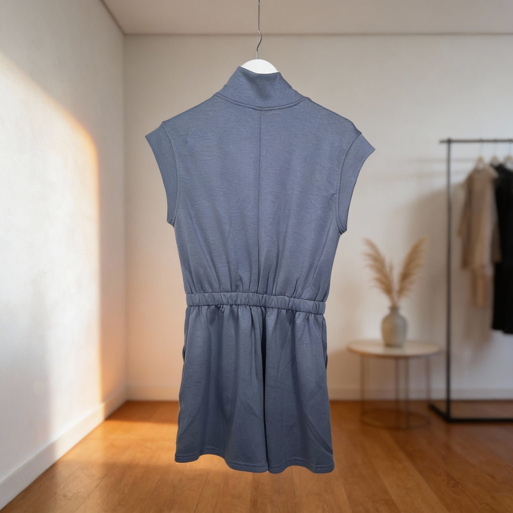 Women’s dusty blue sleeveless half-zip romper featuring an elastic waist and relaxed back fit.