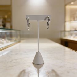 Pair of  Hoop earrings on a stand in a jewelry store setting