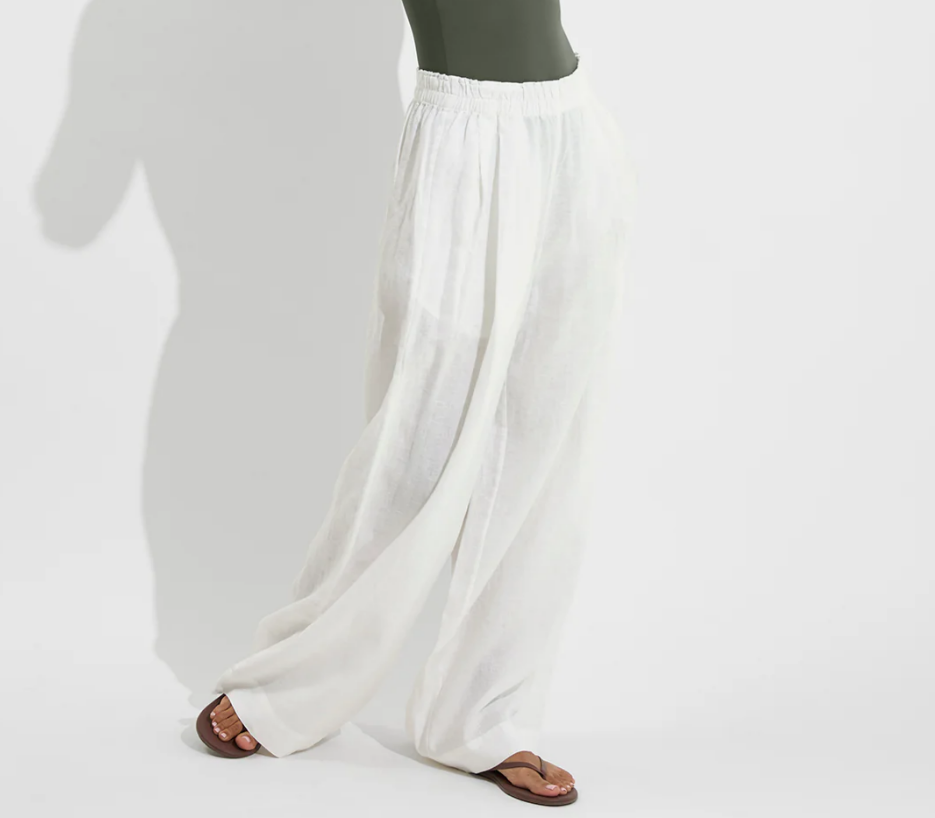 Lightweight white wide-leg coastal pants with relaxed drape and elastic waist