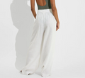 White wide-leg coastal pants with elastic waistband, shown from the back on model