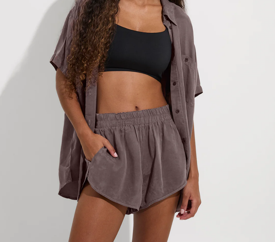 Deep taupe elastic waist shorts styled with black swim top and button-up shirt