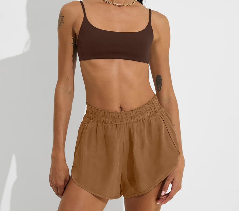 Tan day trip shorts with elastic waistband styled with swim top