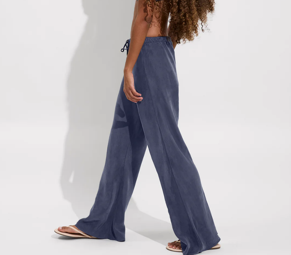 Side view of a person wearing blue drawstring pants for beach and resort wear