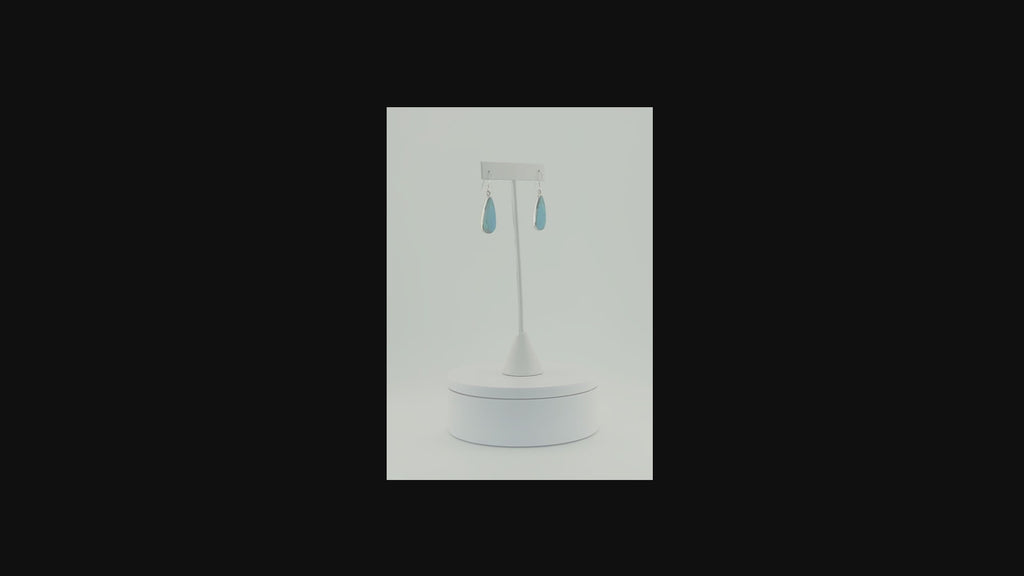 Sterling silver drop earrings featuring turquoise water drop stones video on a turning pedestal 